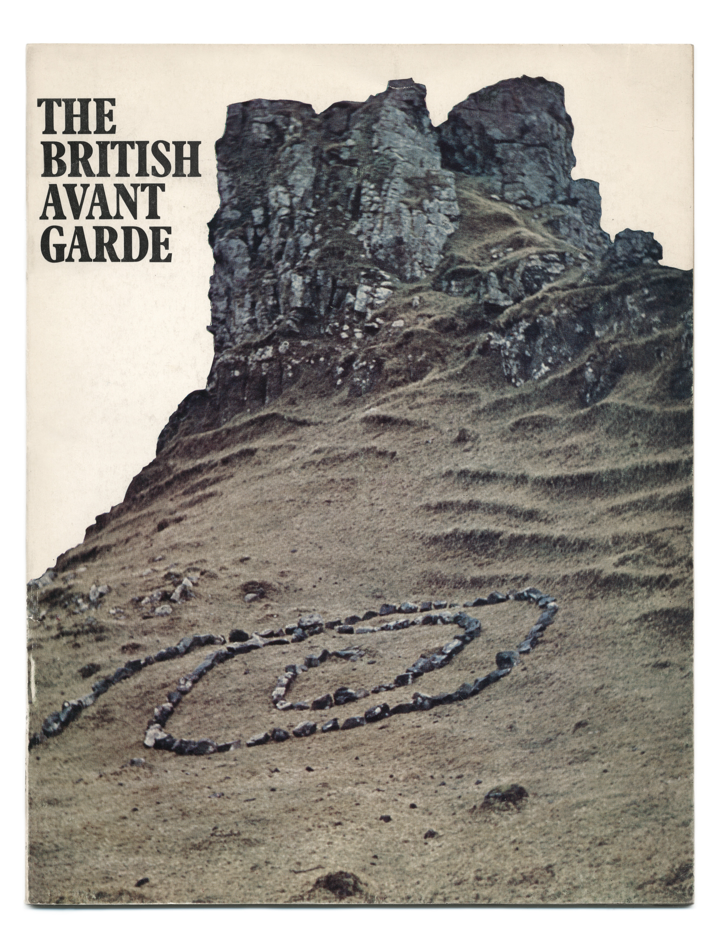 Cover of an exhibition catalogue. Grey stones have been arranged in a spiral on the steep incline leading up to rocky cliffs.